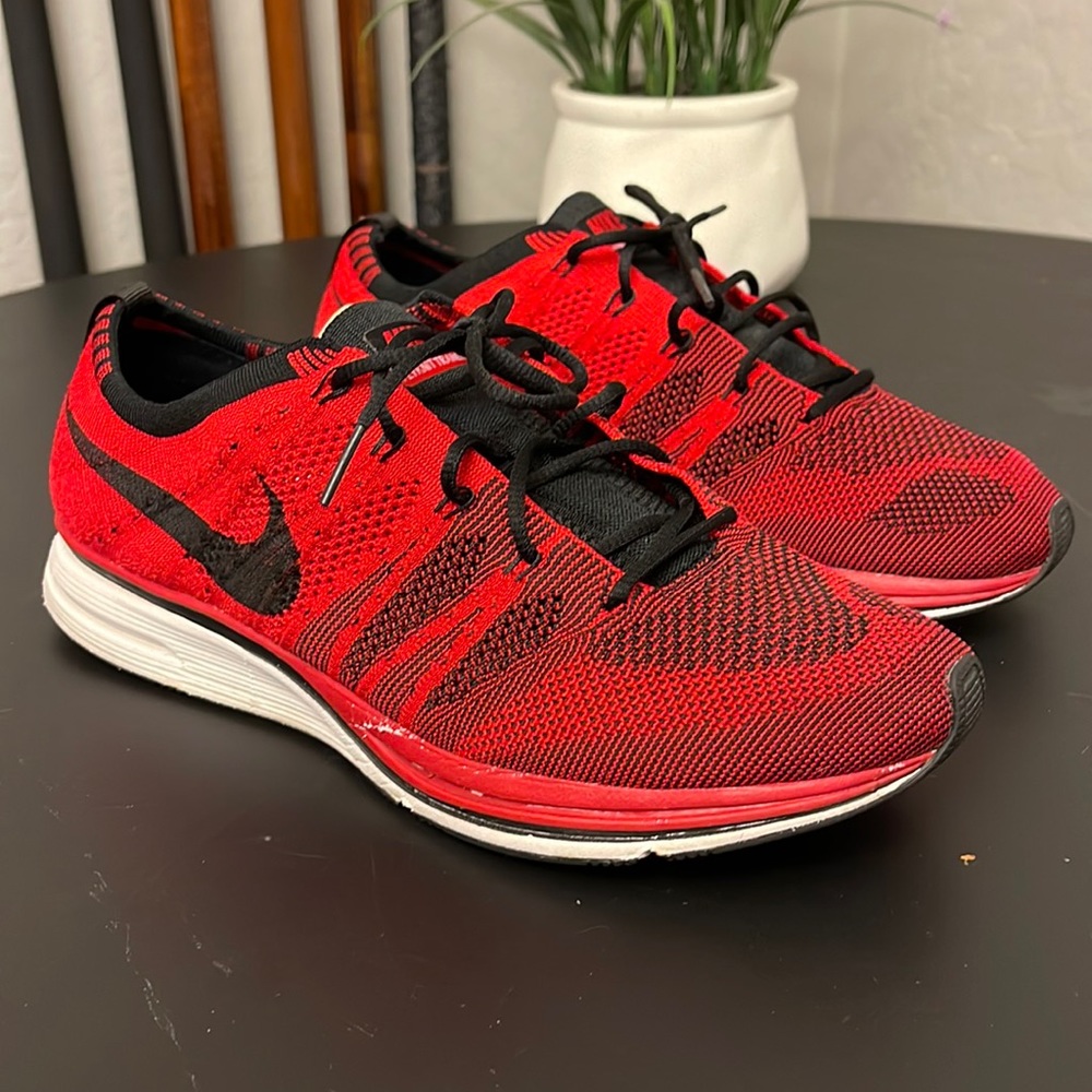 Red and black Nike flyknit trainer